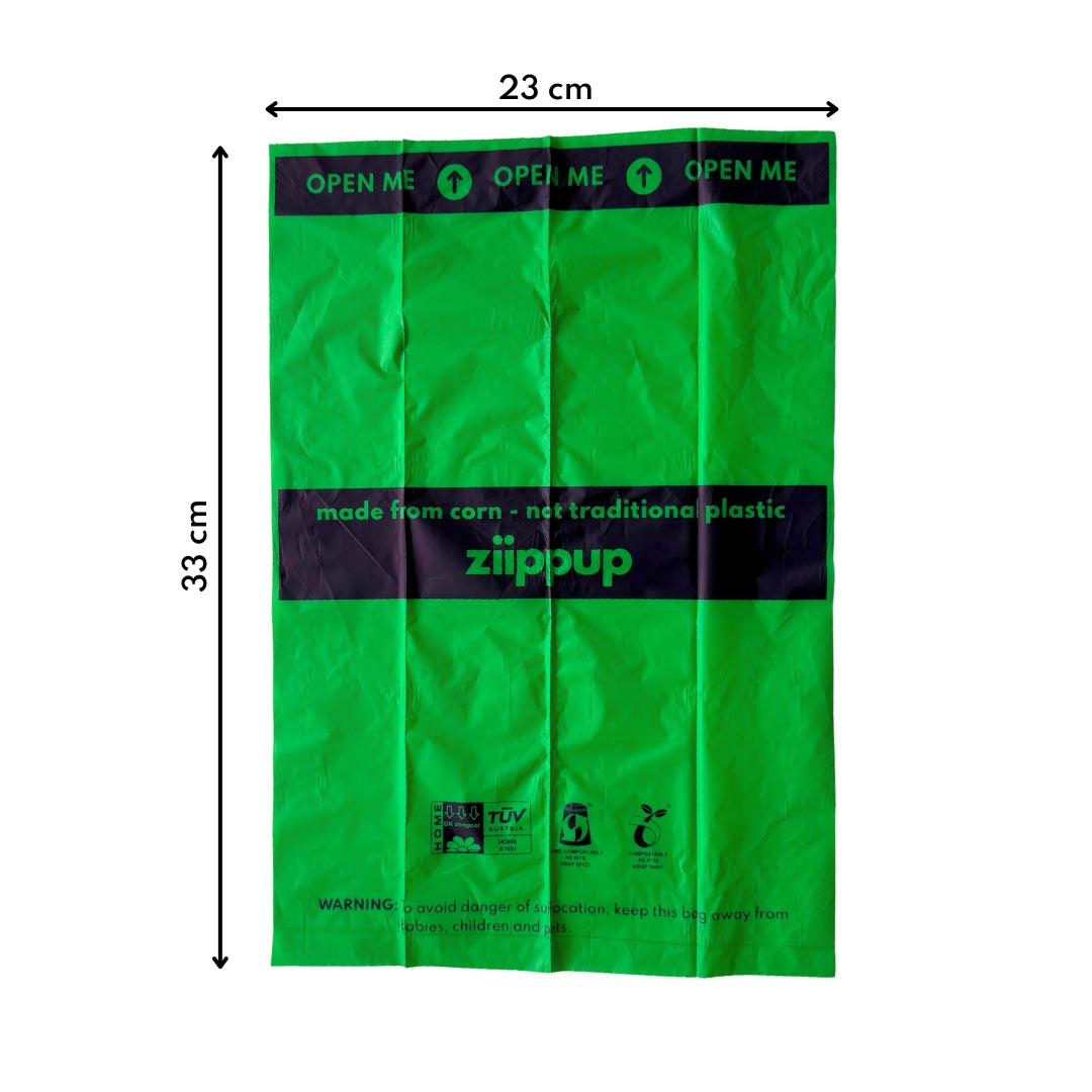 Green compostable dog poo bag with dimensions and text on a white background