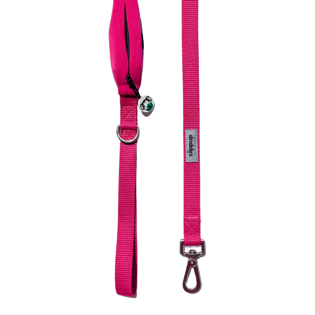 Detailed view of pink dog leash with built-in poop bag holder