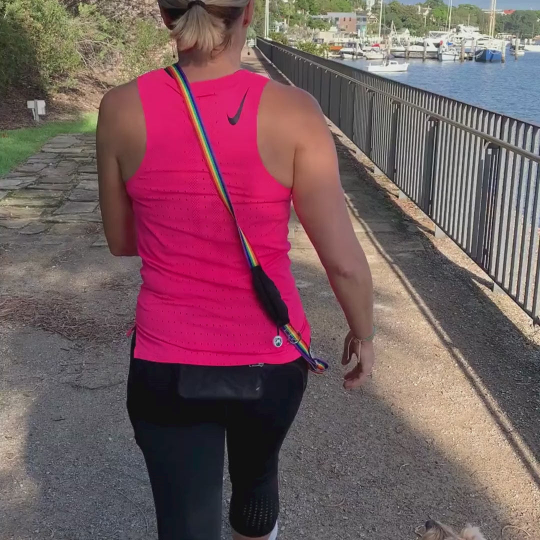 Woman walking hands free leash with with built-in  treat pouch and poo bag holder