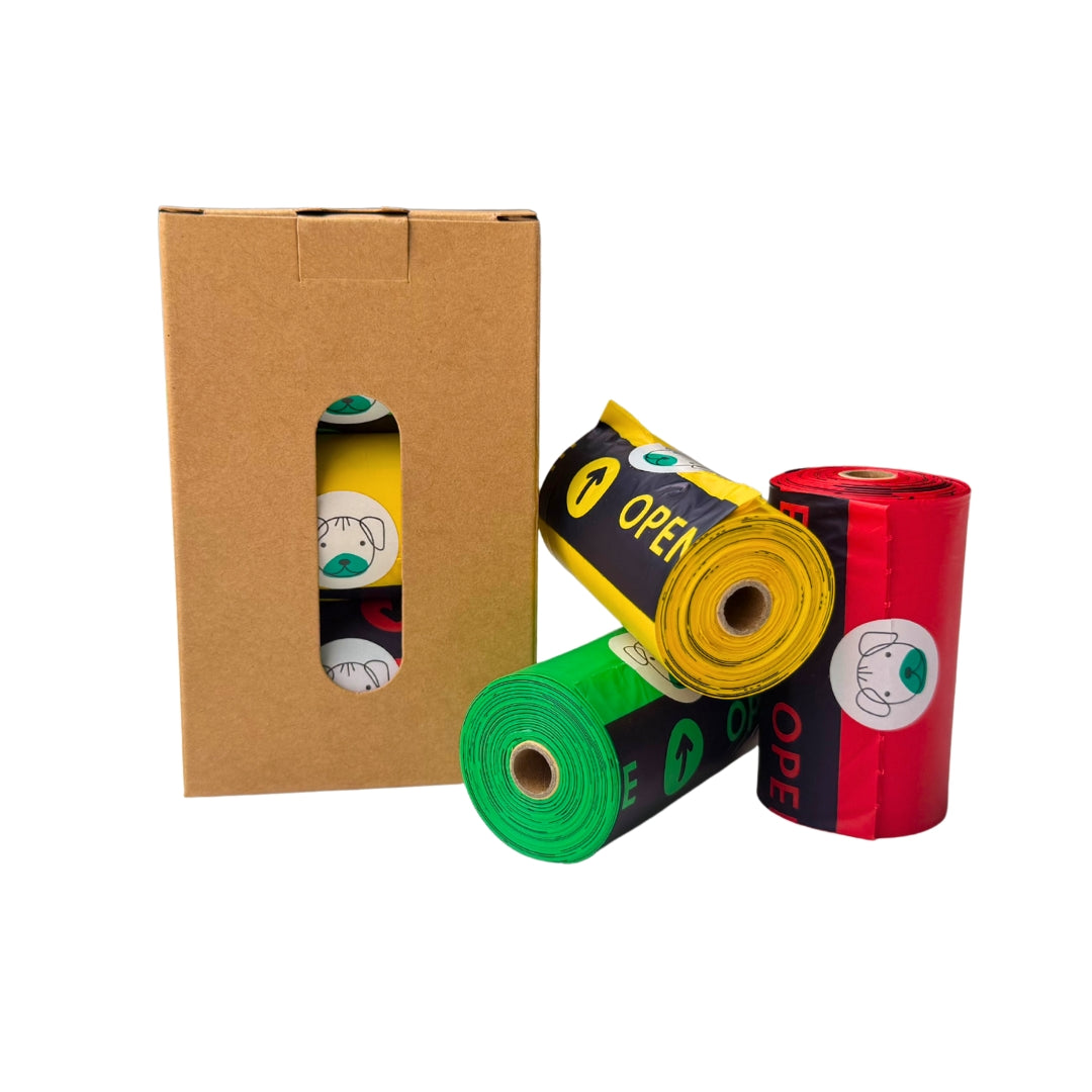 Cardboard box with green, yellow and red rolls of compostable poo bags for dogs