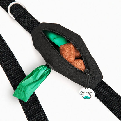 Built-in black poop bag dispenser which is open and filled with dog waste bags and dog treats